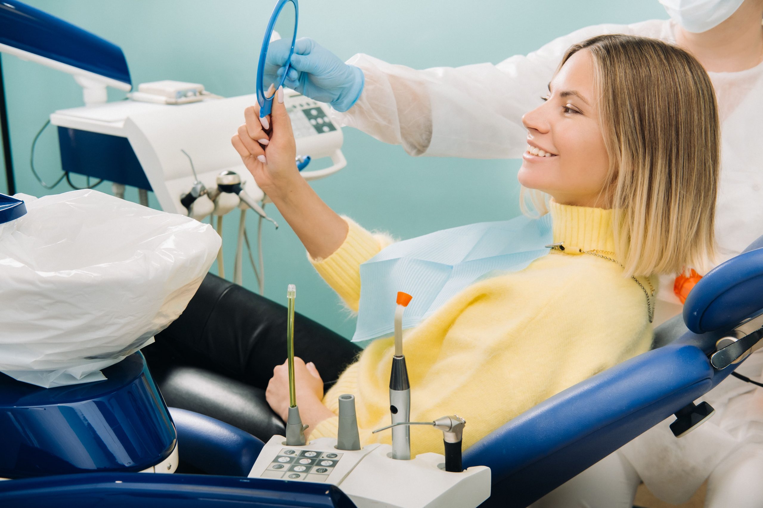 the-girl-smiles-and-looks-in-the-mirror-in-dentist-2021-09-04-02-40-39-utc-min-scaled-1